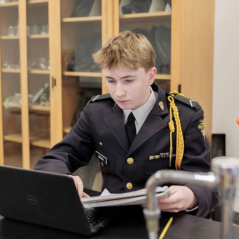 cba student in science classroom with laptop